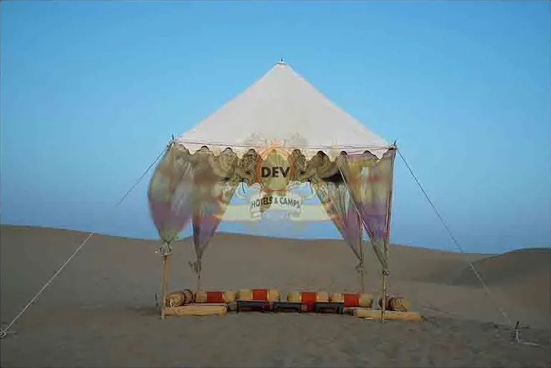 Canopy dinner setting on the dunes