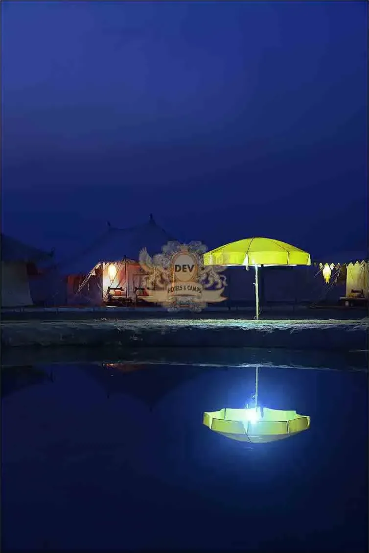 Lit umbrellas reflected in the Talai pond