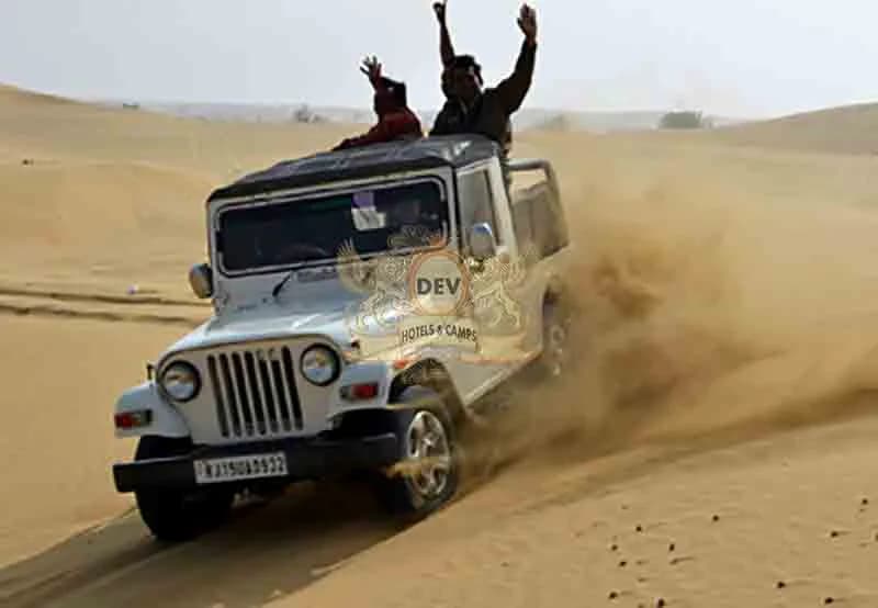 Jeep kicking up sand on the dunes