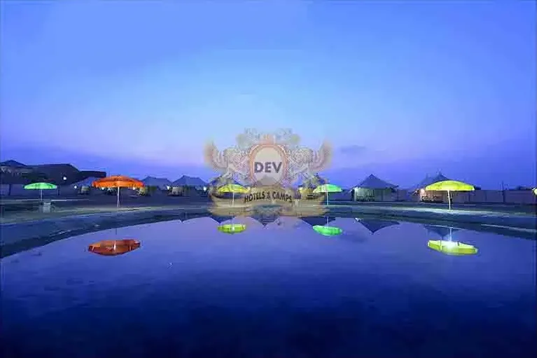 Camp e Khas tents and Talai pond lit up at night